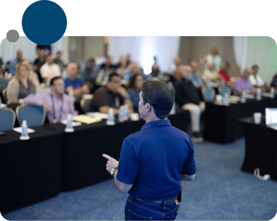 Photo of a WSI consultant leading a peer discussion during a live training event, symbolizing collective learning and real-time collaboration.